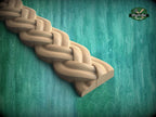 A wooden braided design on a green wooden surface, with a logo for Master Oak visible in the top right corner.