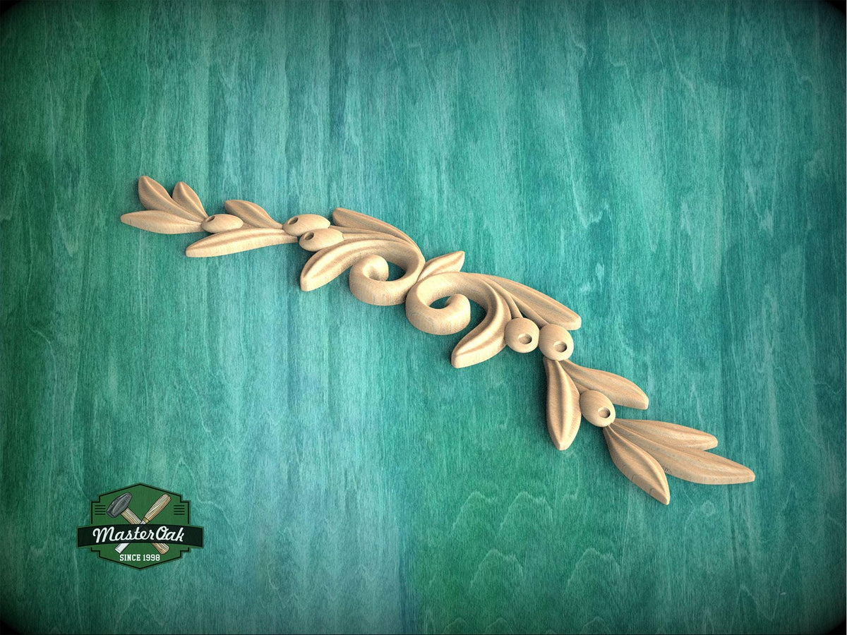a wood carving of a branch with leaves on a green background
