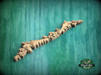 a wooden carving of a plant on a green background