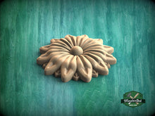 Load image into Gallery viewer, A wooden flower-shaped object is displayed against a green background.
