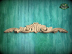 A decorative wooden carving is displayed against a teal-colored background.