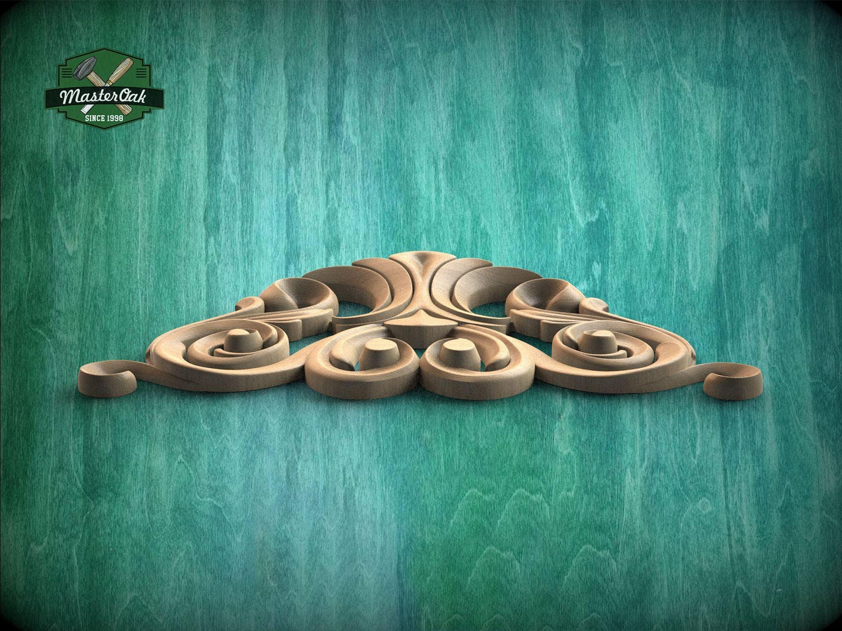 A decorative wooden carving with intricate swirls and curves is displayed against a teal-colored background.