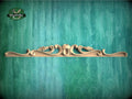 a wooden shelf with a decorative design on it
