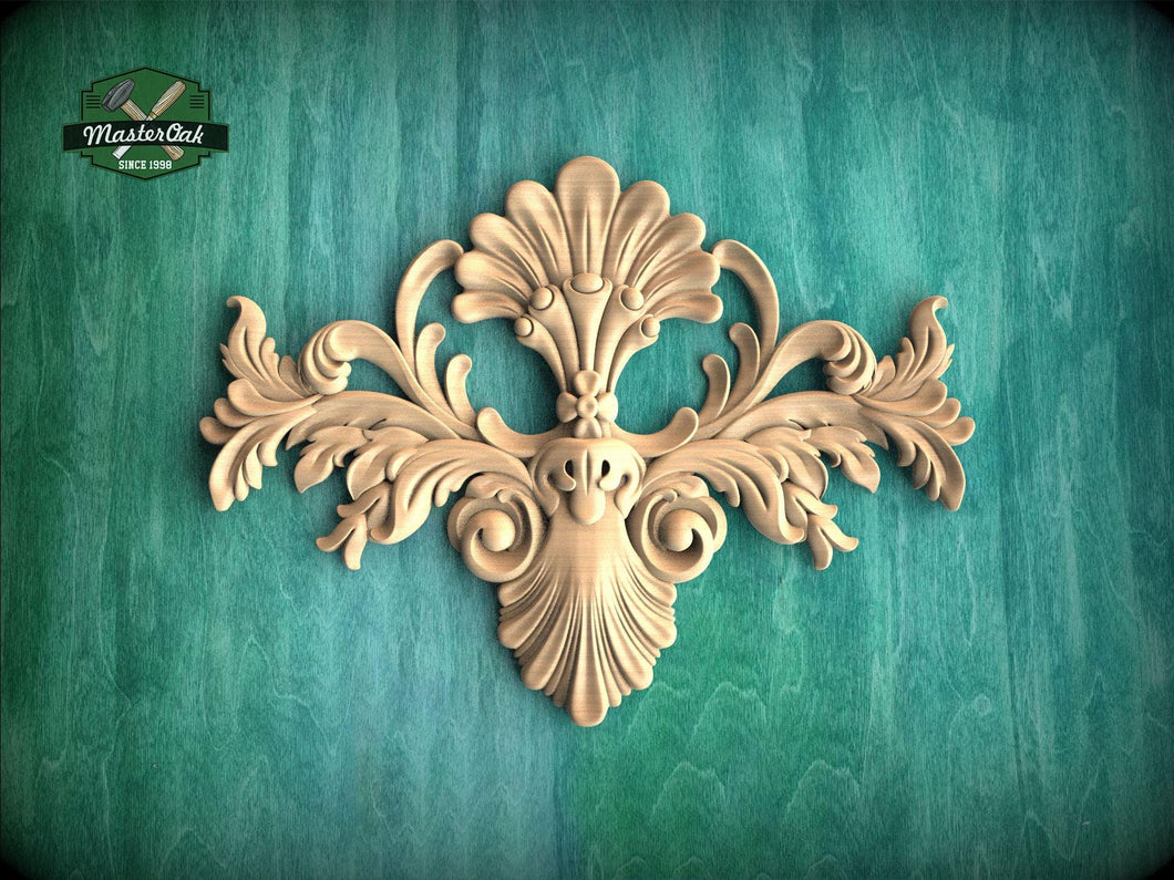 an ornate, carved wooden design with intricate scrollwork and floral elements, set against a green background.