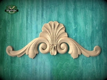 Load image into Gallery viewer, A decorative wooden finial or scroll with an intricate, ornate design is displayed against a teal-colored background.
