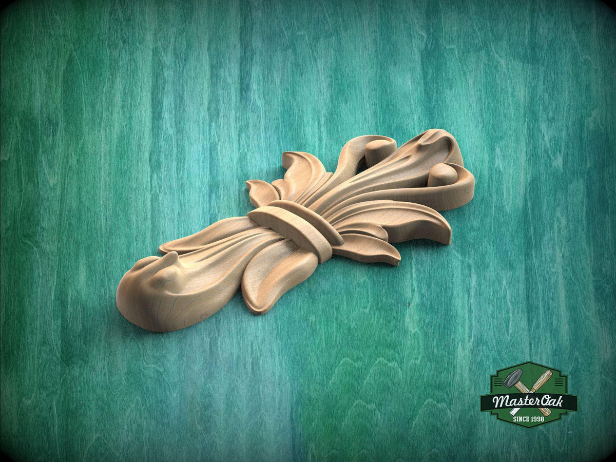 A wooden carving of a stylized flower or leaf design is displayed against a green background.