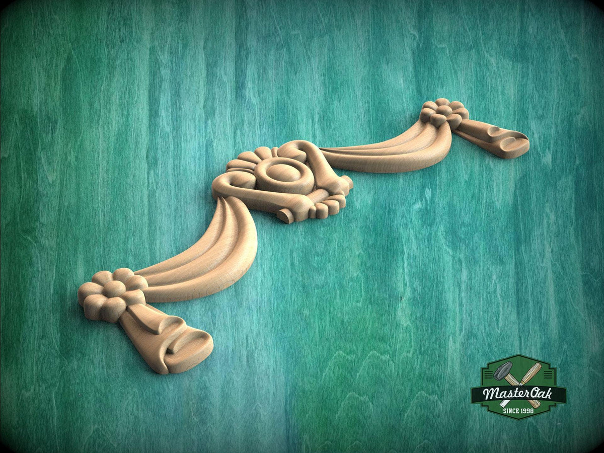 A decorative wooden carving with intricate floral and scrollwork designs is displayed against a green textured background.