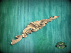 a wood carving of an ornate design on a green background