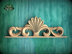 A decorative wooden carving with a stylized shell-like design is displayed against a teal-colored background.