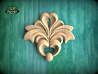 a decorative wooden carving on a green background.