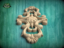 Load image into Gallery viewer, a decorative wooden carving with intricate floral and scrollwork designs, set against a green background.

