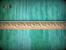 Load image into Gallery viewer, a decorative border made of carved wood, set against a green wooden background.
