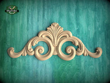 Load image into Gallery viewer, a decorative wooden carving on a teal background.
