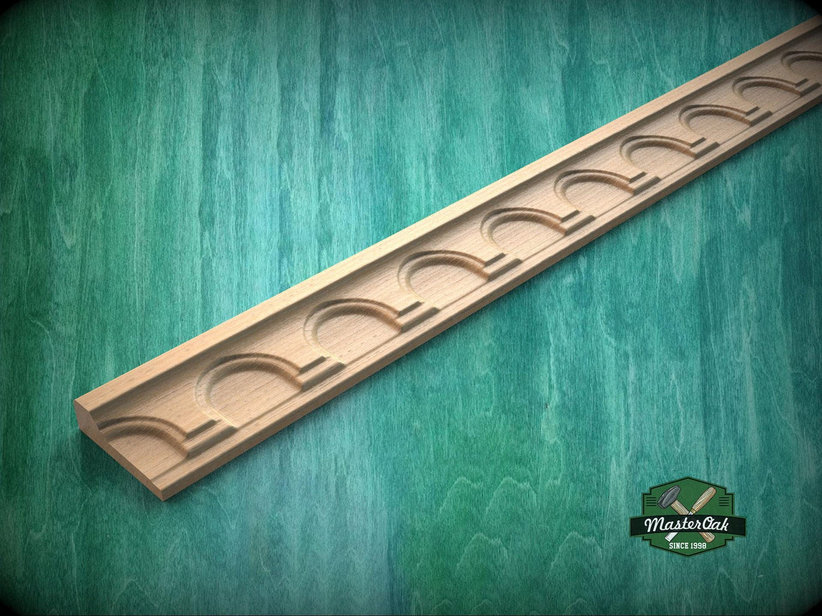 Carved wooden molding with repeating arch pattern used as decorative trim for wall panels, cabinets or furniture.