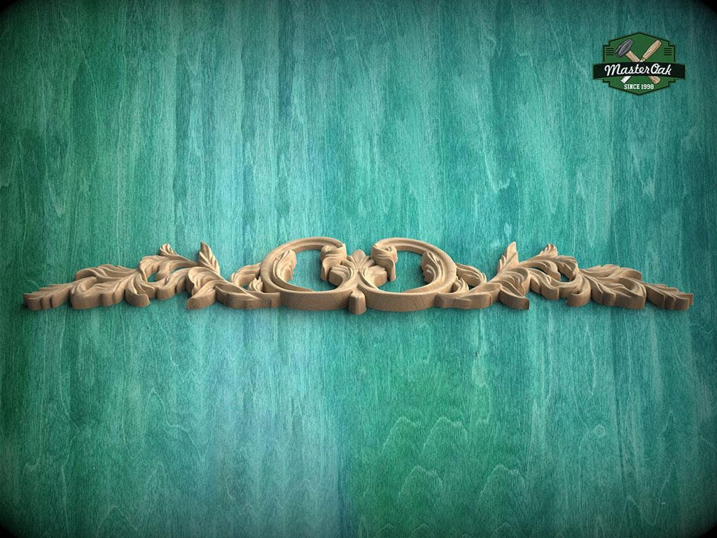 A decorative wooden carving with intricate floral patterns is displayed against a textured green background.