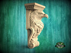 A carved wooden eagle head mounted on a wall, with a decorative scroll design around it.