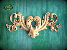 Load image into Gallery viewer, a decorative wooden carving on a green background.
