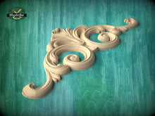 Load image into Gallery viewer, A decorative wooden carving with intricate scrollwork is displayed against a teal background.
