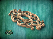 Load image into Gallery viewer, A wooden carving with intricate scrollwork and floral patterns is displayed against a teal background.
