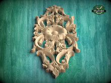 Load image into Gallery viewer, an ornate, carved wooden panel with intricate floral and leaf designs, set against a green background.
