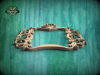 A wooden ornate frame with intricate scrollwork and a shell-like design, set against a green wooden background.