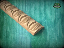 Load image into Gallery viewer, A wooden carving with a curved, organic shape is displayed against a green background.
