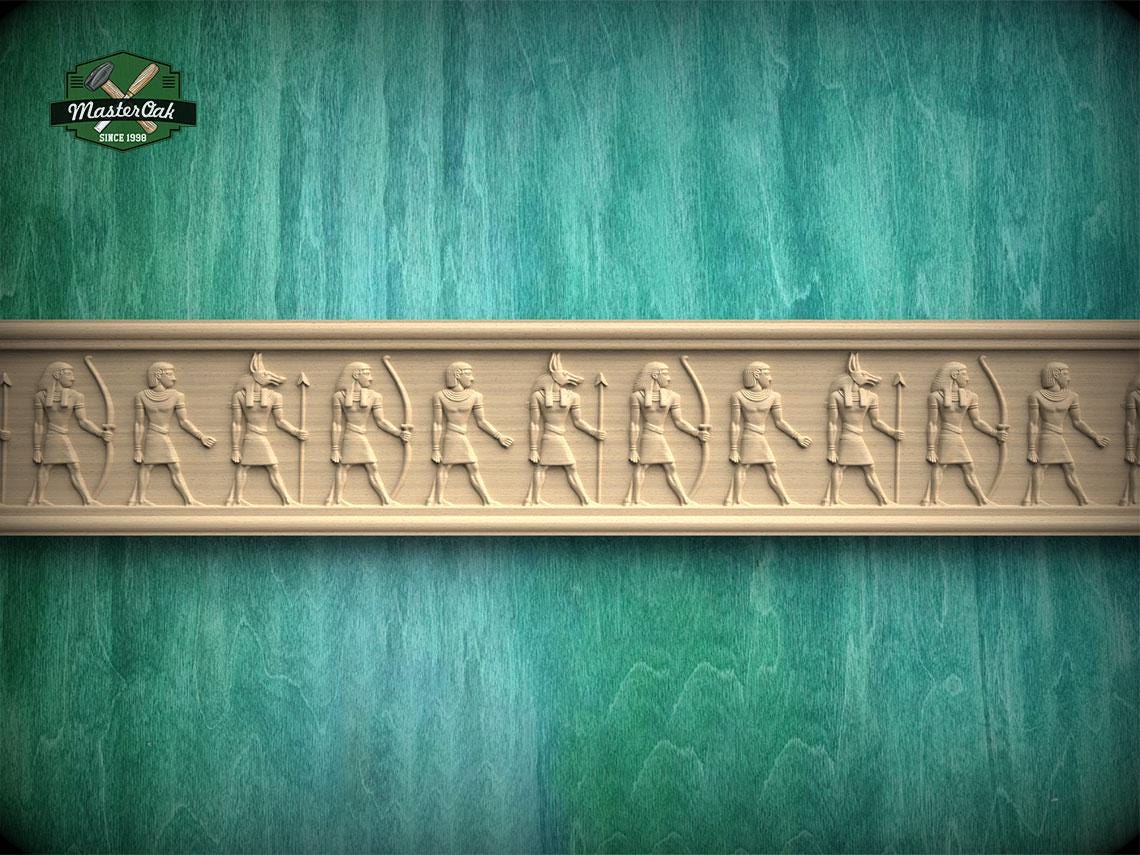 a row of carved figures on a wooden surface, with a teal-colored background.