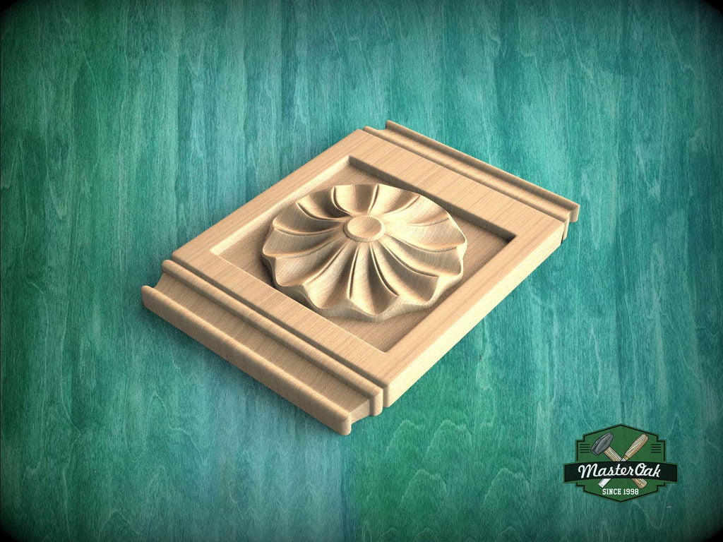 A wooden carving of a flower-like design is displayed on a wooden surface against a green background.