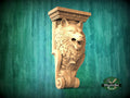 A carved wooden wolf head on a wall, with a decorative scroll design around it, against a green background.