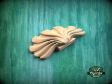 Load image into Gallery viewer, A wooden carving of a leaf-like shape is displayed against a green background.

