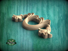 Load image into Gallery viewer, A wooden carving of a stylized flower or plant-like shape is displayed against a green background.
