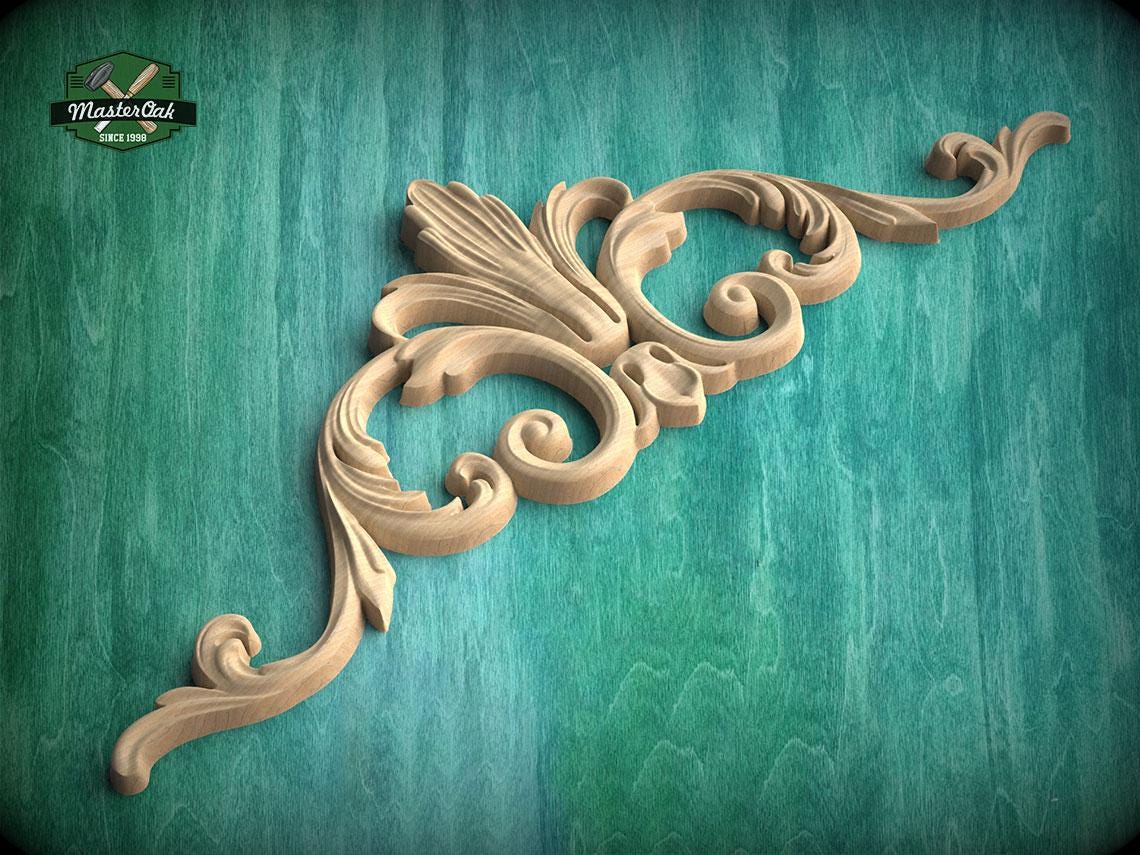 A decorative wooden carving with intricate scrollwork is displayed against a teal background.