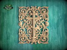 Load image into Gallery viewer, an ornate, carved wooden cross with intricate floral and scroll designs, set against a teal background.
