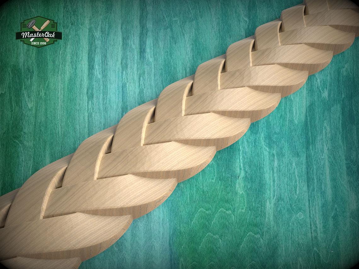 A close-up view of a wooden braided pattern on a green wooden surface.