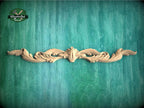a wood carving of a flower on a green background