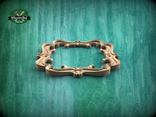 Load image into Gallery viewer, A decorative wooden frame with an ornate, curving design is displayed against a green textured background.
