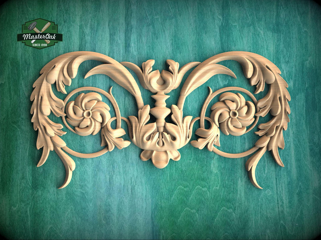 a decorative wooden carving with intricate floral and leaf-like patterns, set against a green background.