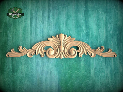a wood carving of an ornate design on a green background