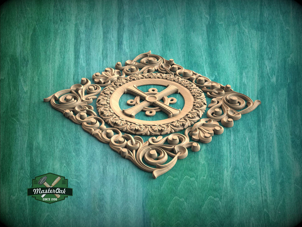 a decorative wooden carving with an ornate design, including a central cross surrounded by intricate scrollwork and floral elements, set against a teal background.