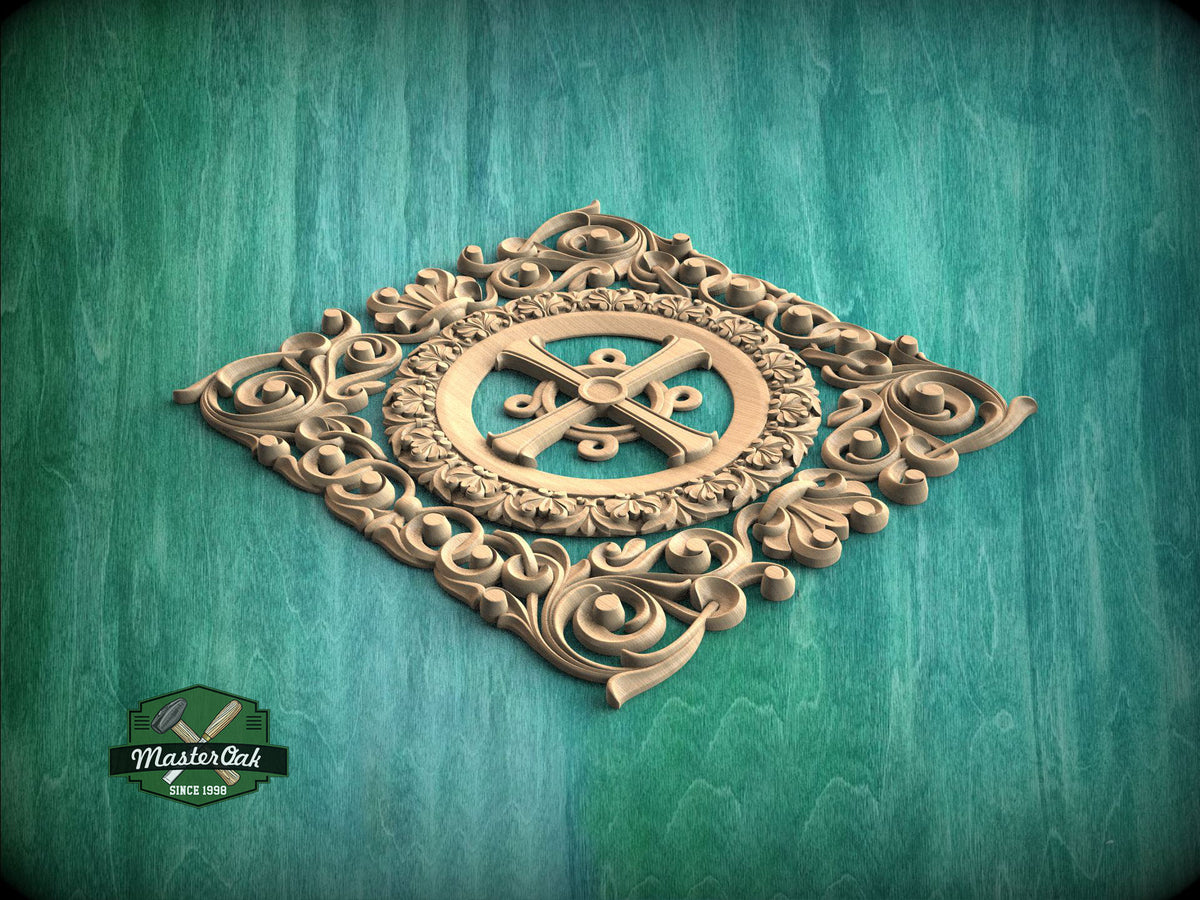 a decorative wooden carving with an ornate design, including a central cross surrounded by intricate scrollwork and floral elements, set against a teal background.