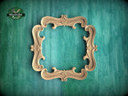 a wooden ornate frame with intricate scrollwork, set against a green textured background.