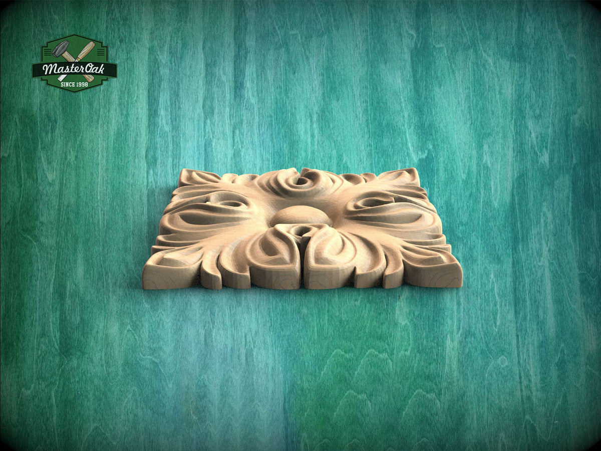 A square wooden carving with a floral design is displayed against a green wooden background.