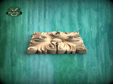 Load image into Gallery viewer, A square wooden carving with a floral design is displayed against a green wooden background.
