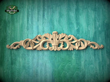 Load image into Gallery viewer, a decorative wooden carving on a green background.
