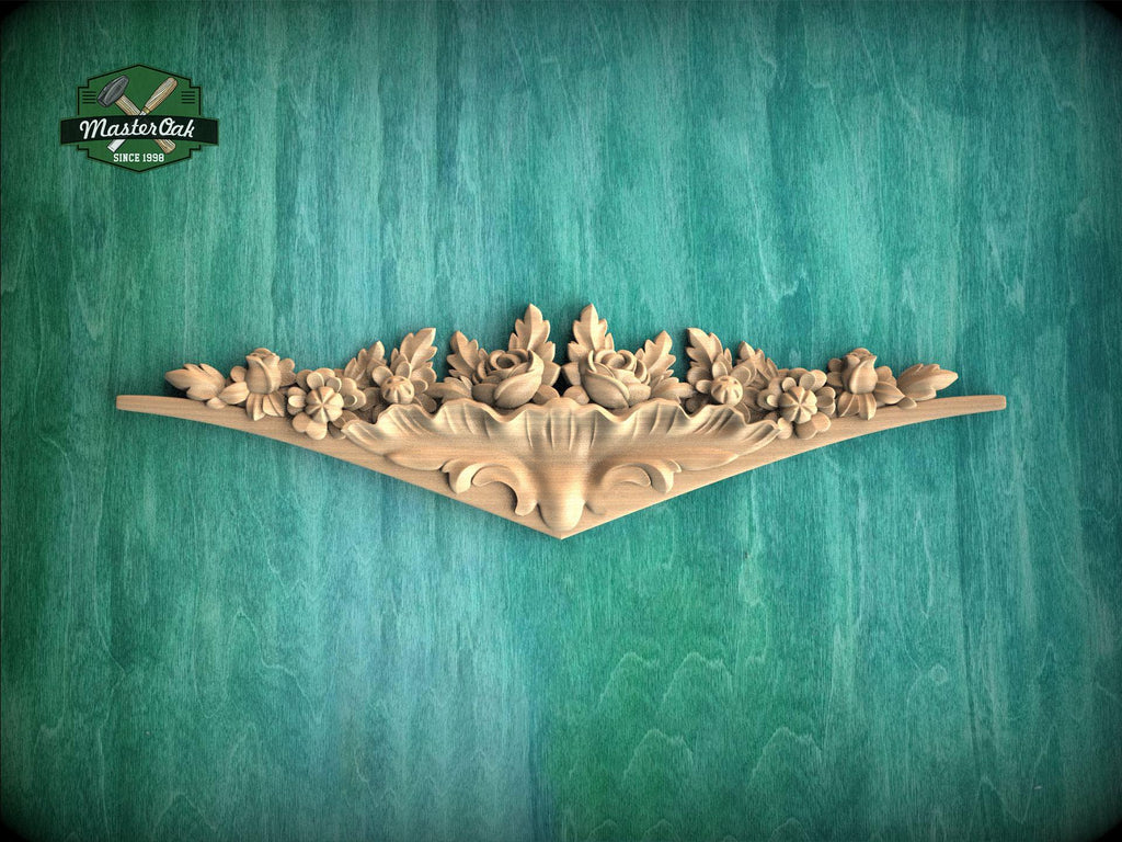 A decorative wooden carving with floral and leaf-like designs is displayed against a green textured background.