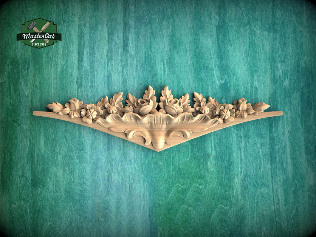 A decorative wooden carving with floral and leaf-like designs is displayed against a green textured background.