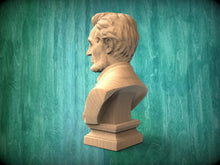 Load image into Gallery viewer, A wooden bust of a man is displayed against a green background.

