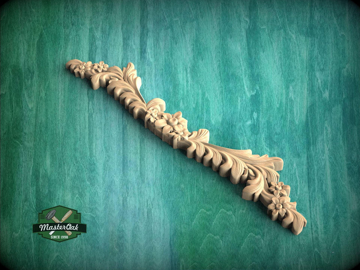 a wood carving of a floral design on a green background