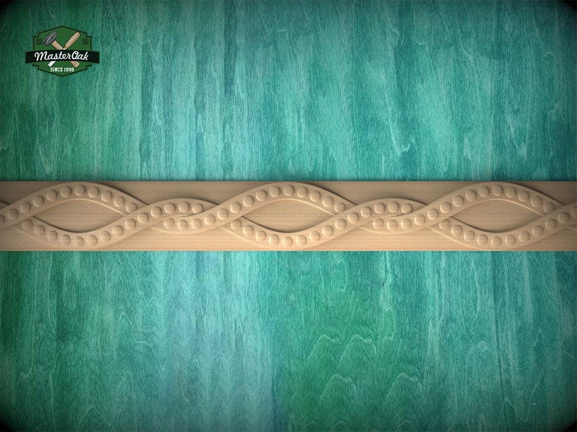 a wooden border with a decorative design on a turquoise background.