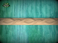 Load image into Gallery viewer, a wooden border with a decorative design on a turquoise background.
